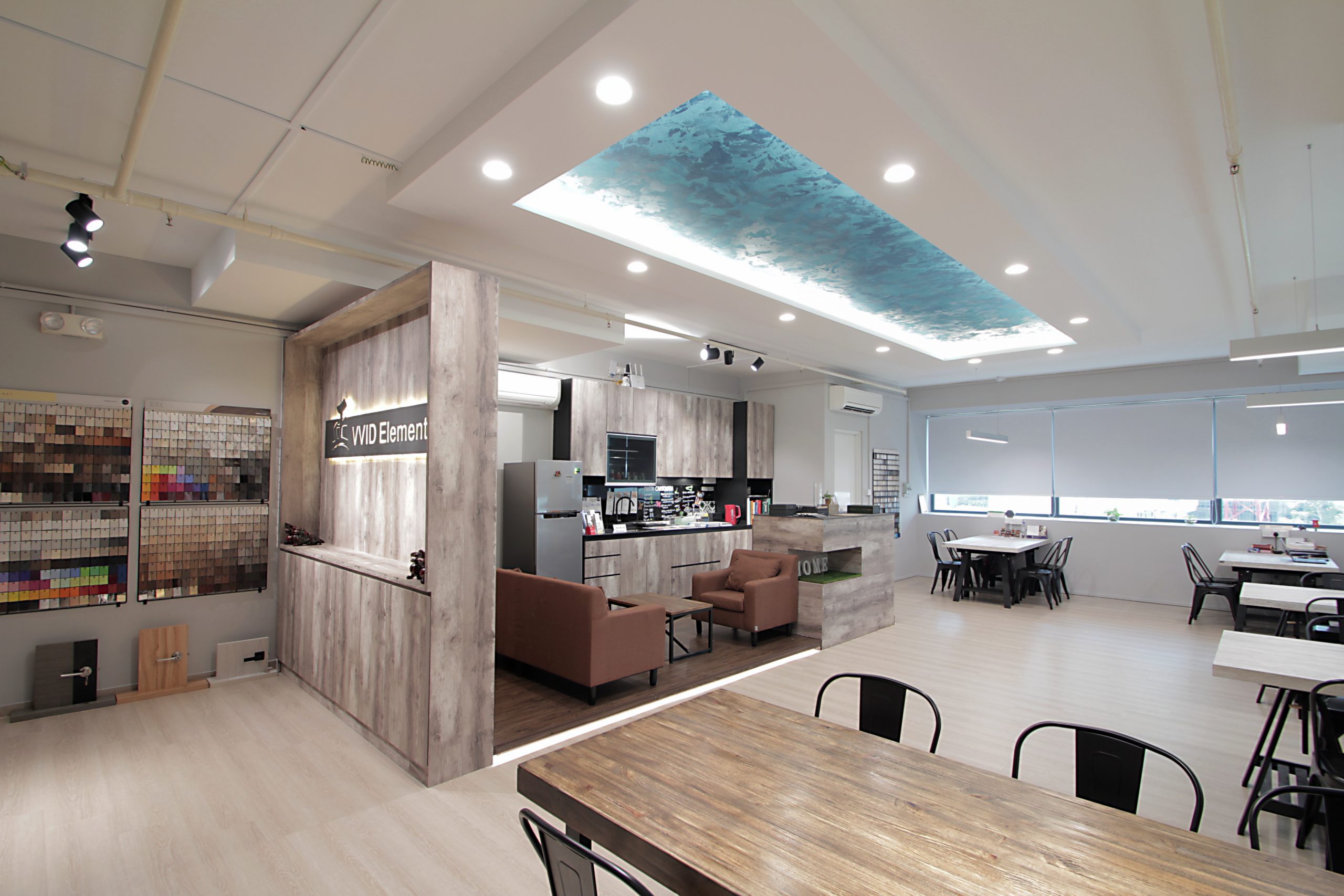 An open concept office design with evenly designed lightings to illuminate the working space.