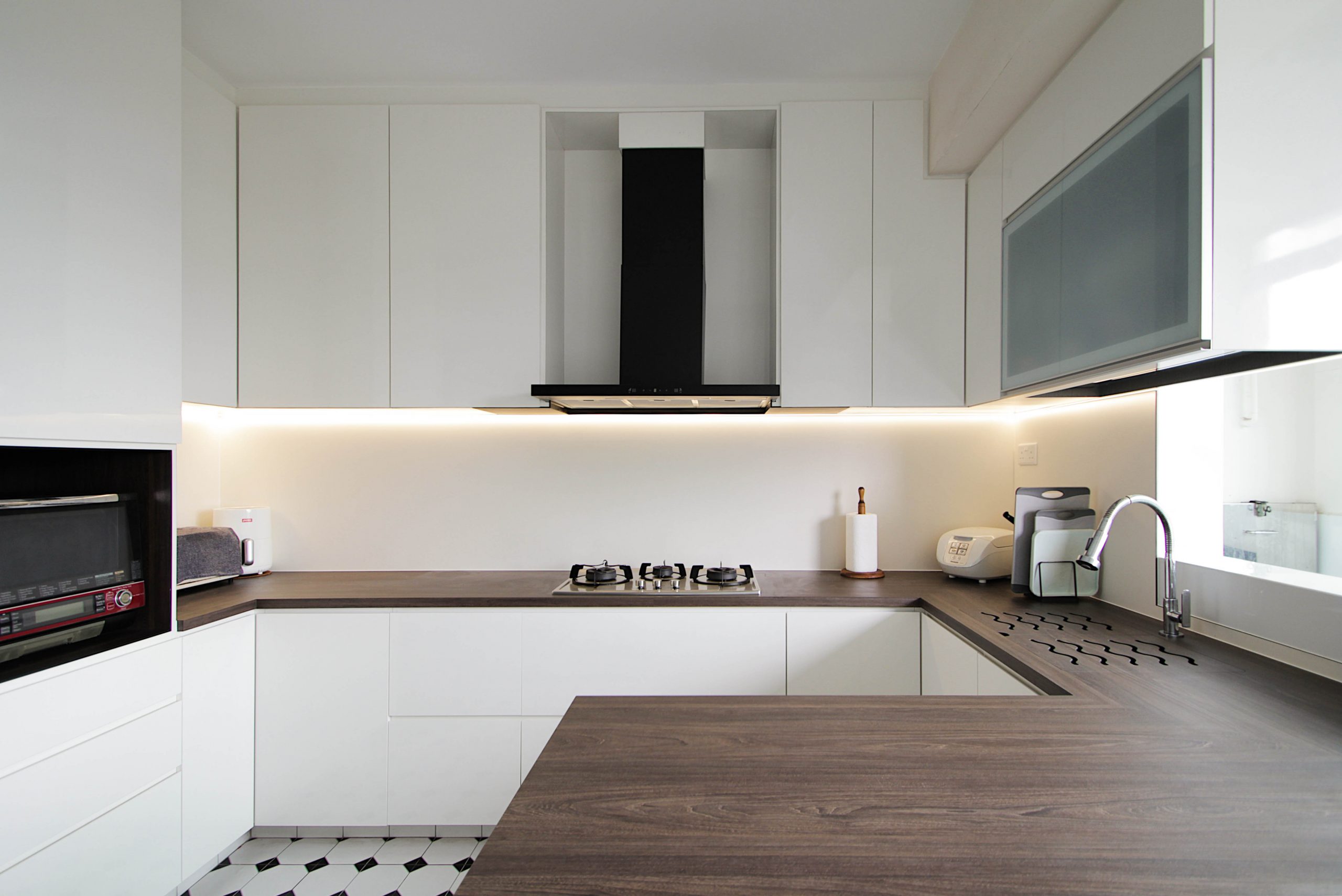 An upgrade of existing kitchen with new U-shape cabinet stretching to a standing island topped off with a impact and stain resistant worktop customized storage space.