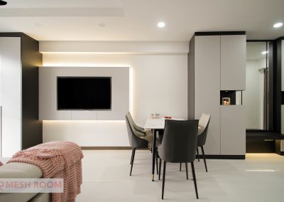 Customized carpentry works to maximize storage space yet allowing lots of living space throughout the entire home with a hidden workstation tucked into the corner of the living room. With a mix of neutral tone laminates, soft furnishing and well placed lightings iluminates the entire area and brings about a cosy tone to the enviroment.